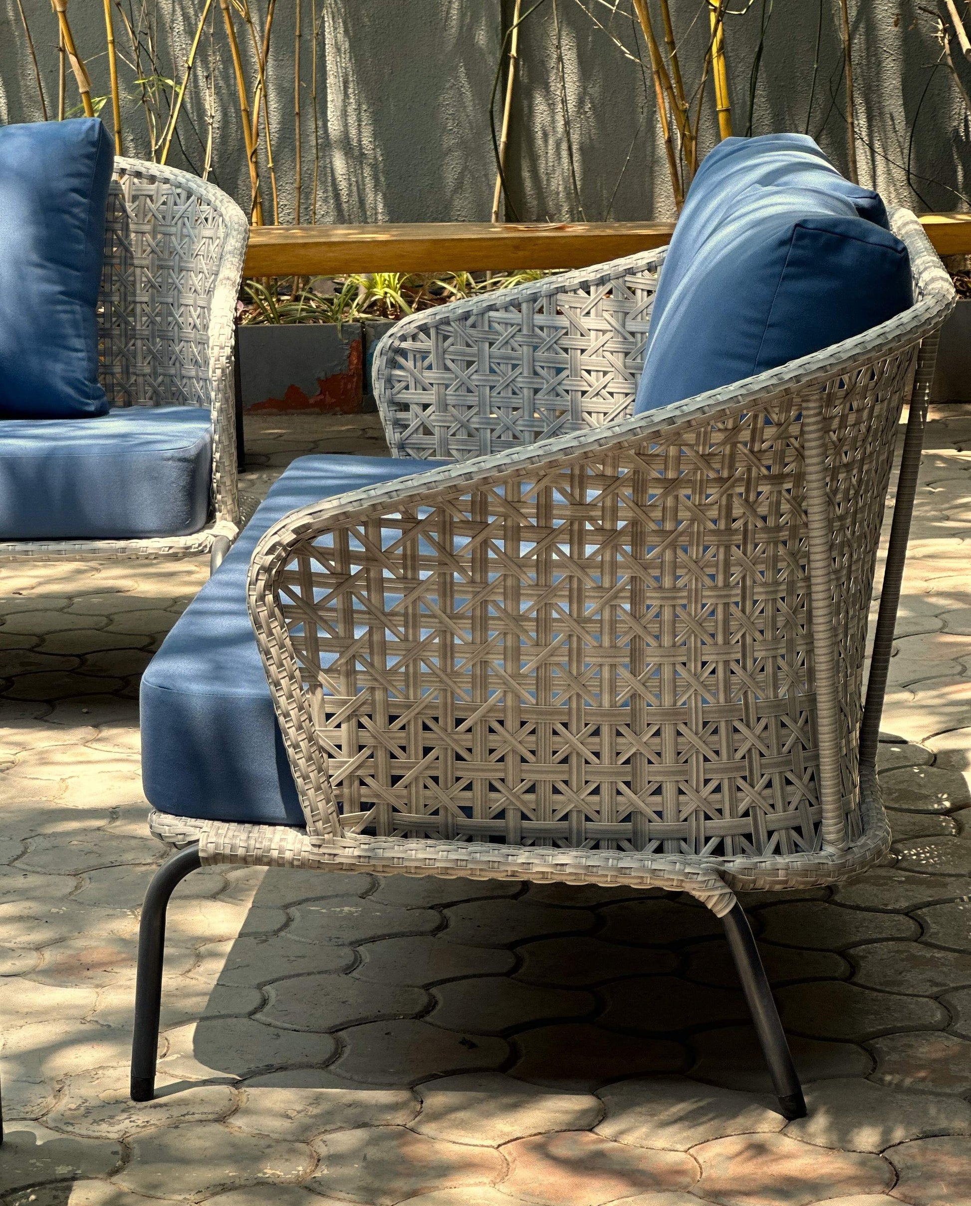 Blue fabric outdoor sofa set with modern design and wicker accents