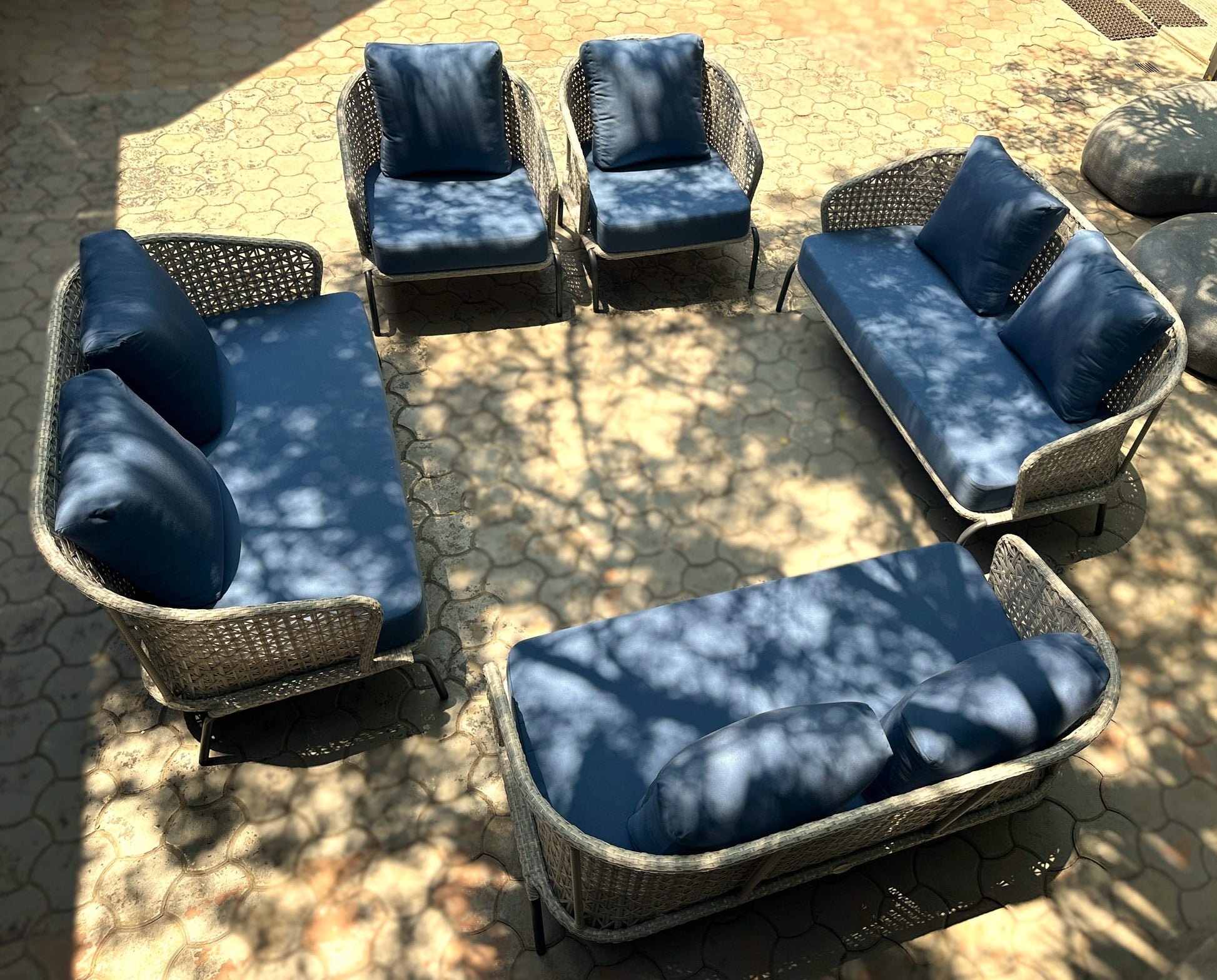 Blue fabric outdoor sofa set with modern design and wicker accents